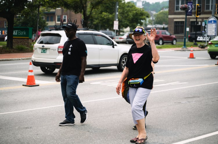 People walking in parade and waving