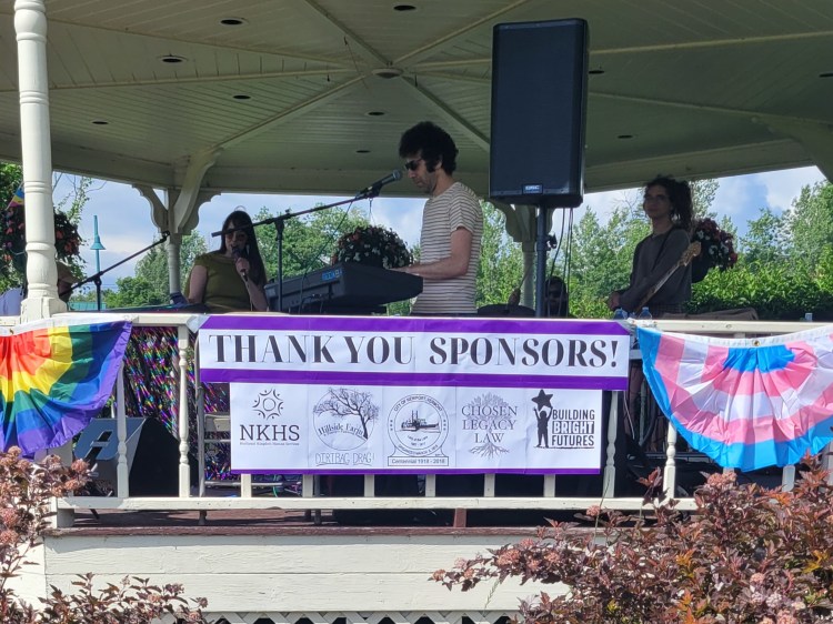 Andriana and the Bananas band with sponsor banner